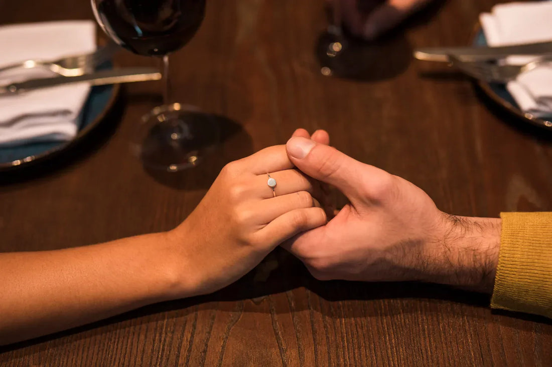 Close-up of a hand with a silver promise ring.