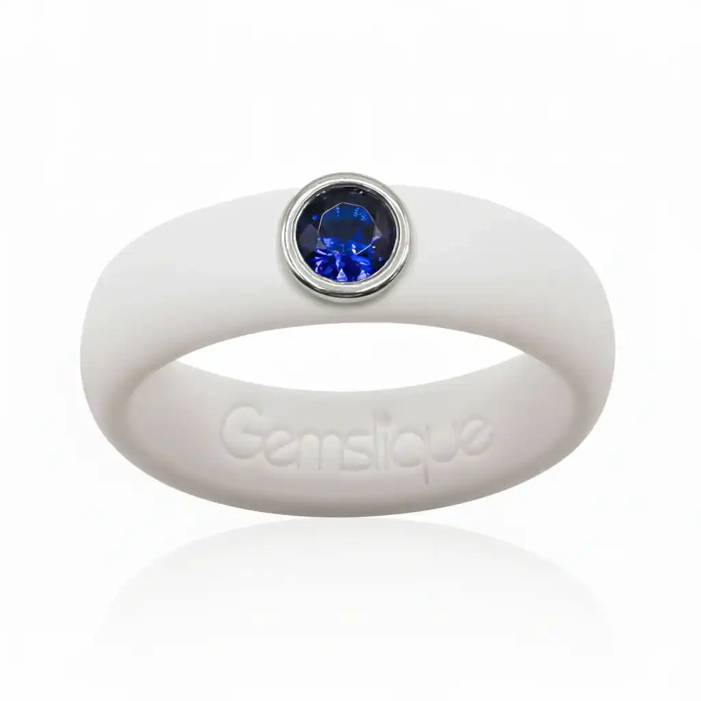 White silicone ring with a blue cubic zirconia gem set in silver bezel