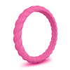 Hot pink silicone ring with twisted design on white background