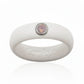 White silicone ring with a pink opal cubic zirconia stone set in silver bezel